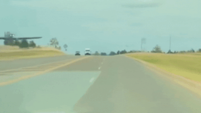 Tesla dashcam captures military plane crash-landing in Oklahoma, narrowly missing car; social media calls it ‘AI-generated’